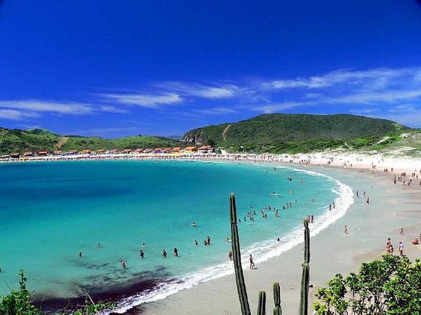 Praia de Cabo Frio - banhistas no mar e vegetação